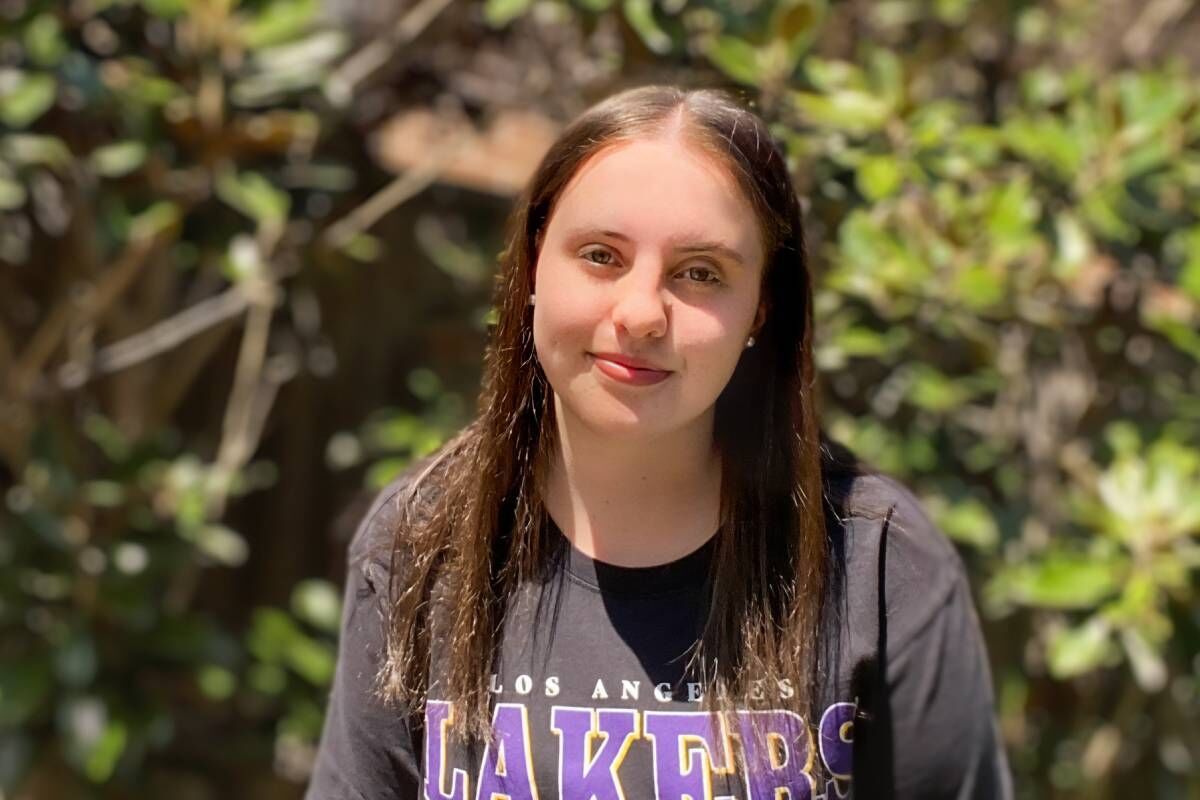 Aleisha Smiling With Trees Behind Her